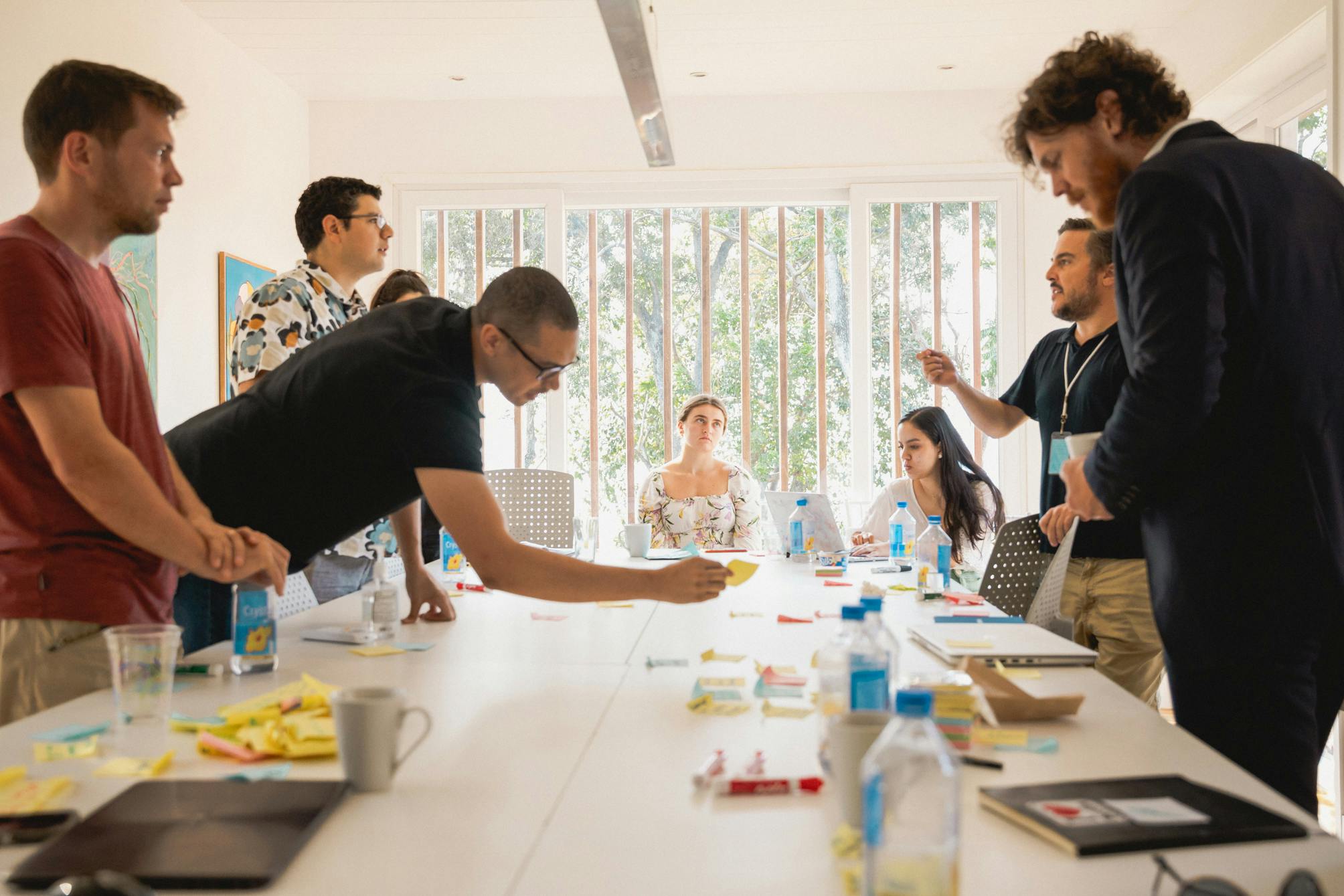 Grupo de personas colaborando en torno a una mesa.